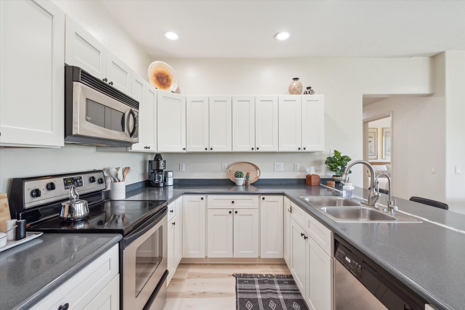 The Kitchen showcases a clean look, stainless steel appliances, and bar seating for four in a stylish, functional layout.