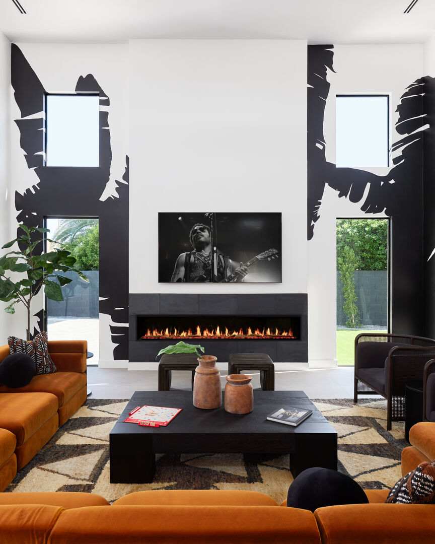 Unit 2: Professionally and intricately designed modern styled living area with large hand-painted mural, 20 ft vaulted ceilings, large electric fireplace, large smart TV, and complete with designer furnishings.