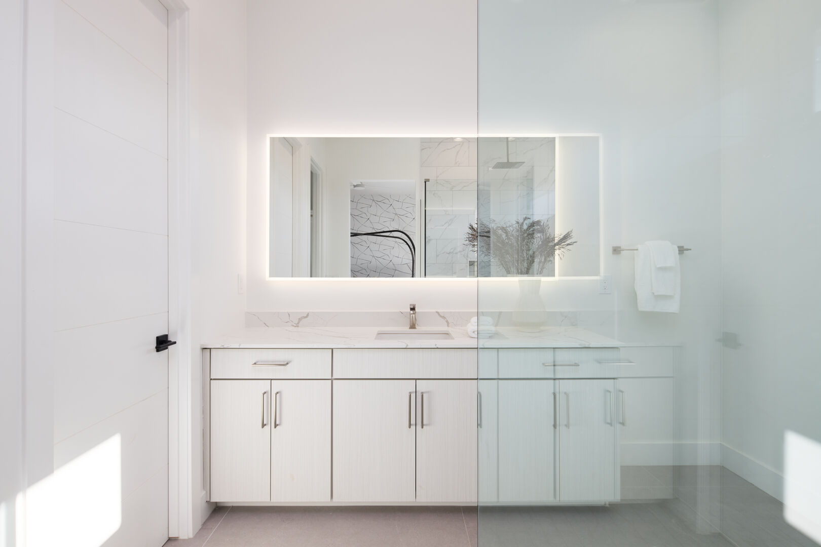 Unit 2: 2nd bathroom attached to 2nd Primary bedroom with large counter single vanity, LED mirrors, and large stand-in shower.