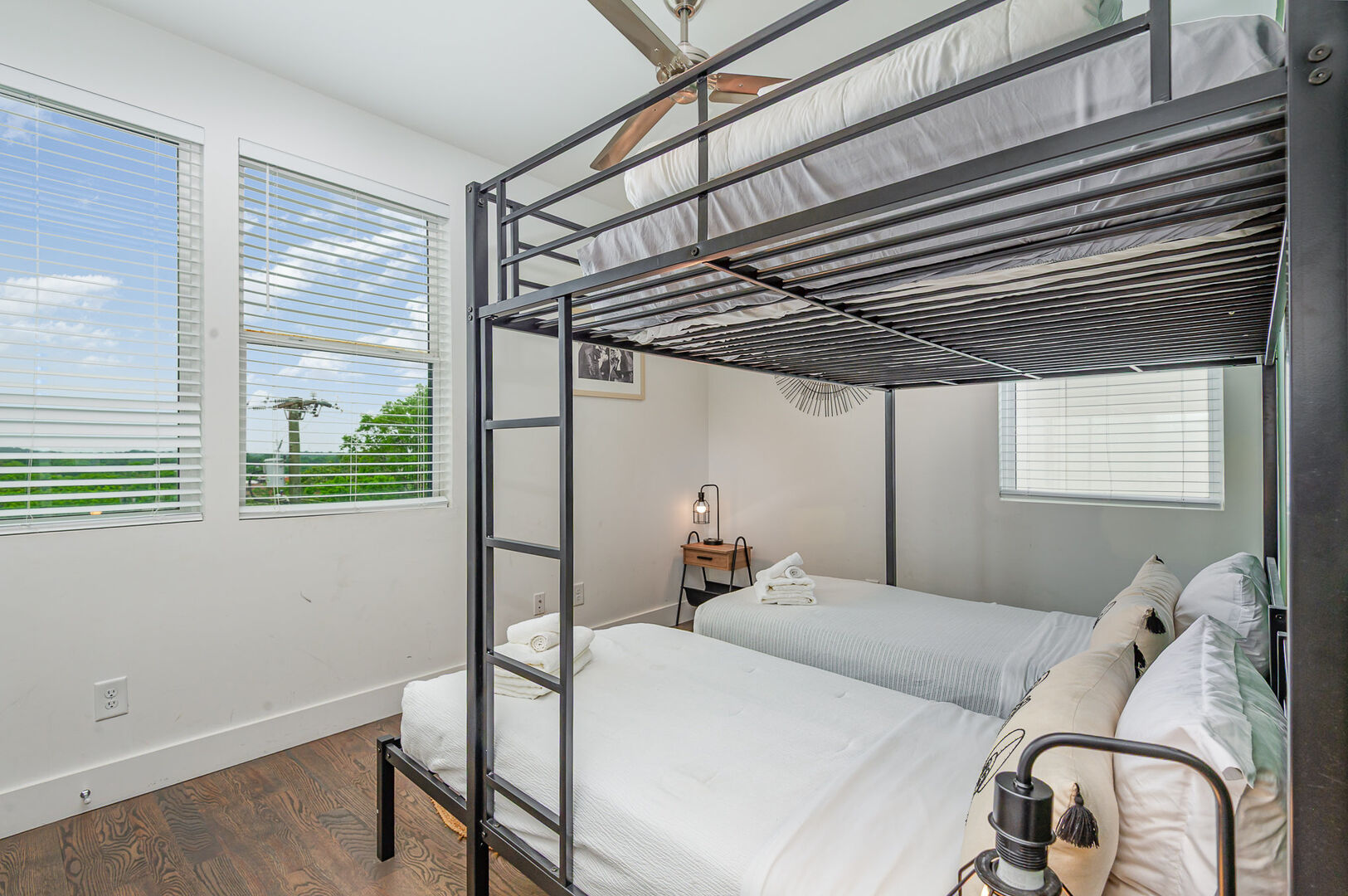 Unit 1: Third Bedroom offers a triple bunk setup with a full-size top bunk and two twin beds below.
